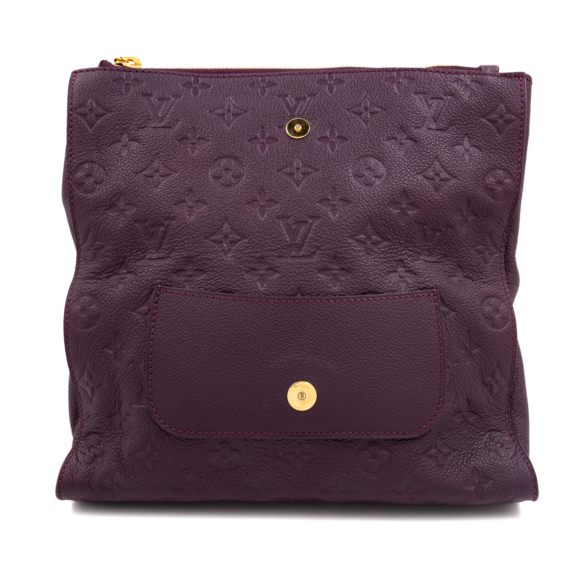 A Louis Vuitton Plum Monogram Empreinte Leather Petillante Clutch, 7" H x 10.75" W x 2.5" D.