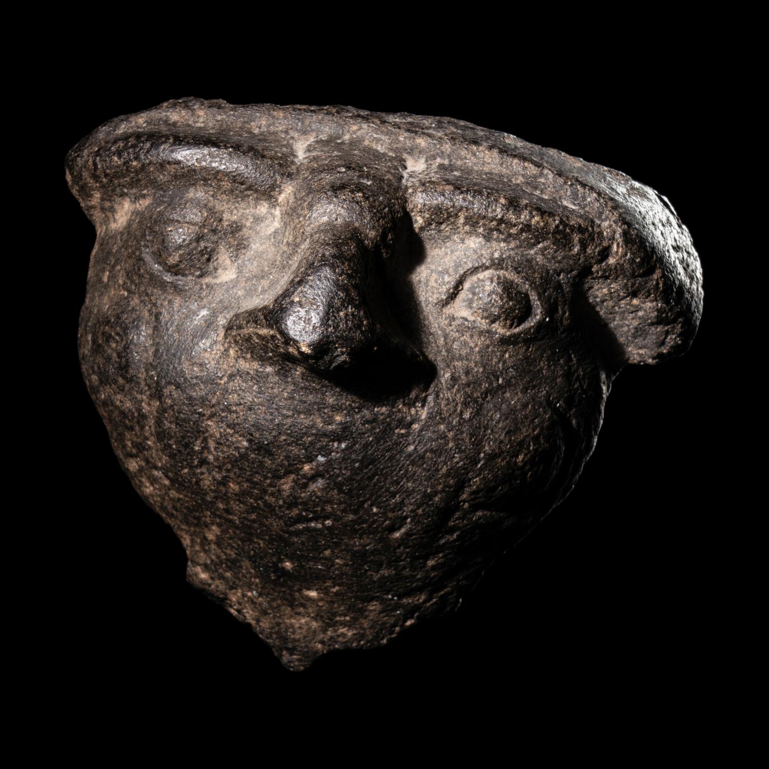 An Egyptian Basalt Falcon Face Fragment