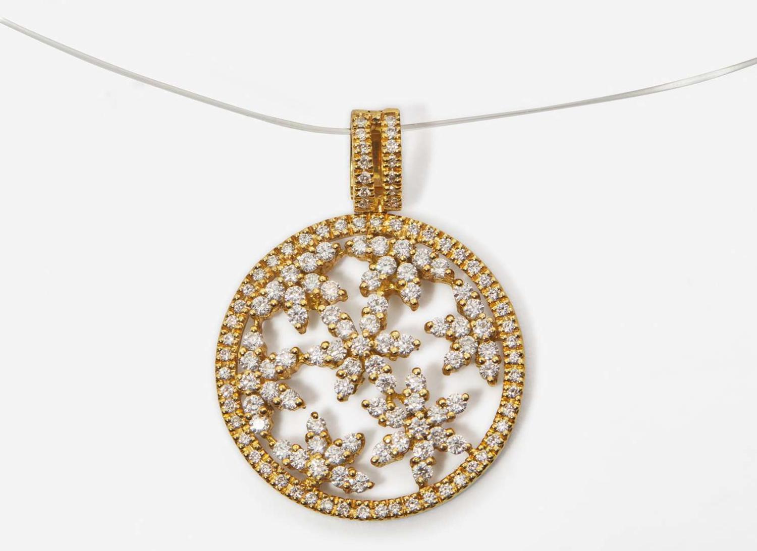 An 18K Yellow Gold and Diamond Pendant on a Lalique Cord
