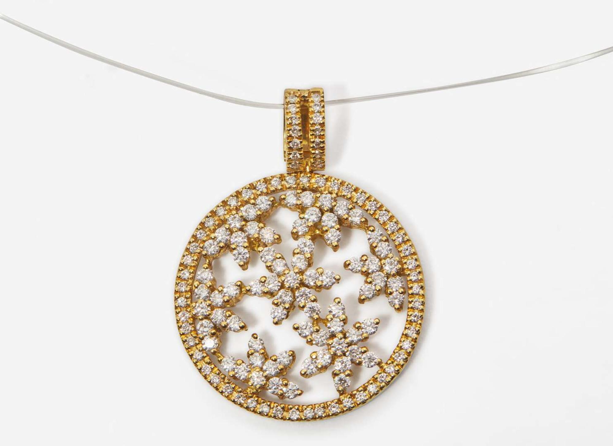 An 18K Yellow Gold and Diamond Pendant on a Lalique Cord