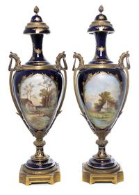 A Pair of Sevres Gilt Bronze Mounted Porcelain Urns Height 29 inches.