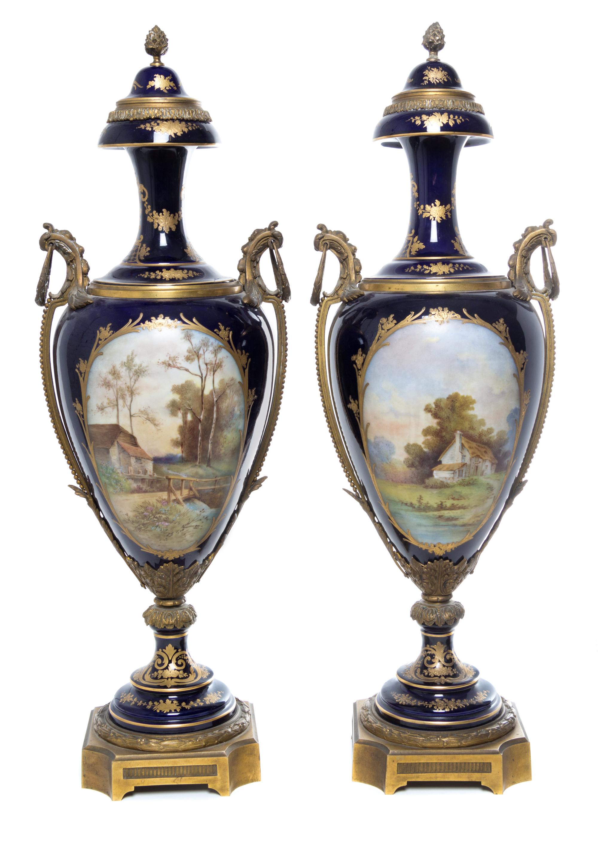 A Pair of Sevres Gilt Bronze Mounted Porcelain Urns Height 29 inches.