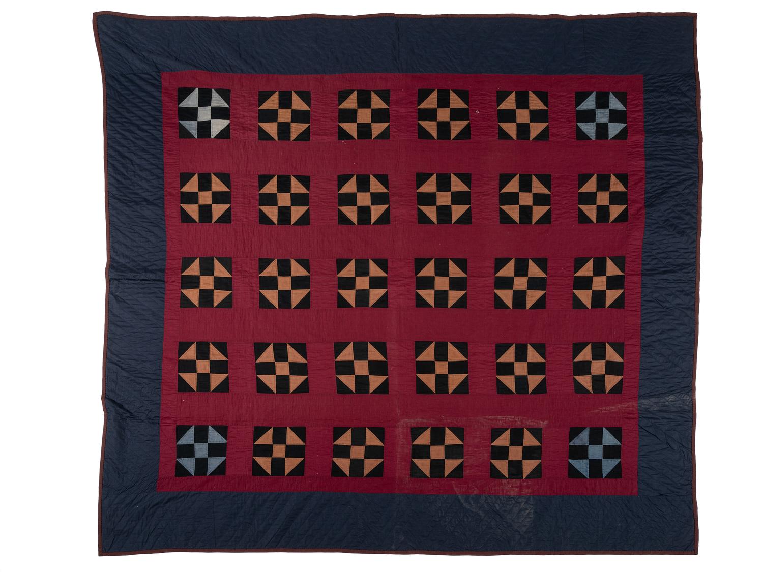 A Red, Orange, Black and Navy Blue Pieced Cotton Quilt