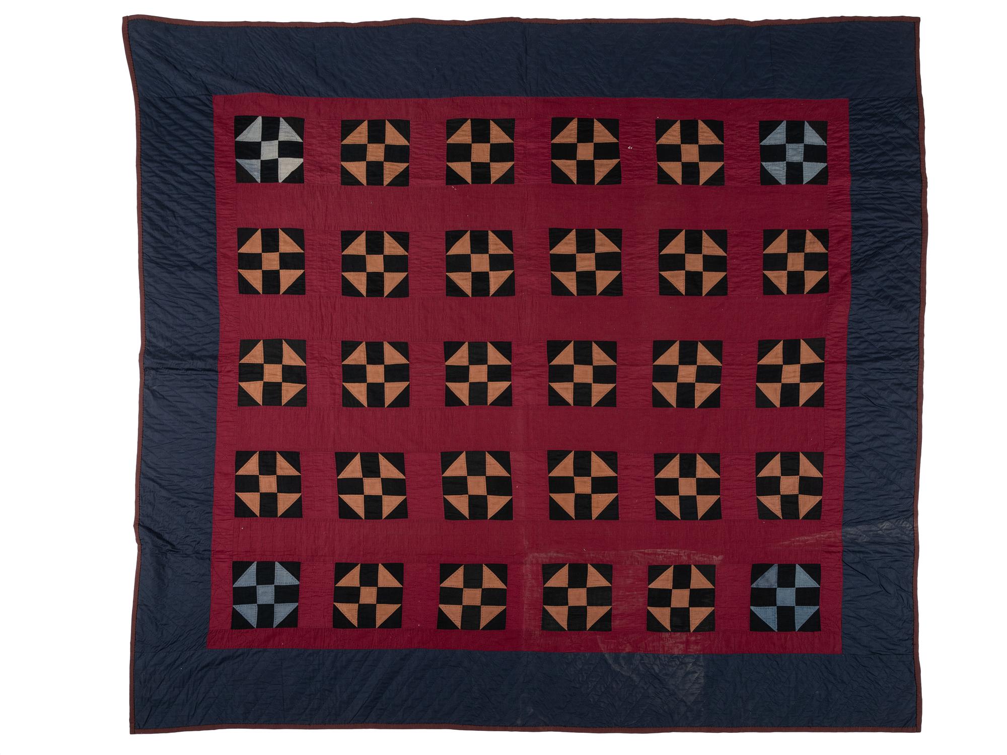 A Red, Orange, Black and Navy Blue Pieced Cotton Quilt
