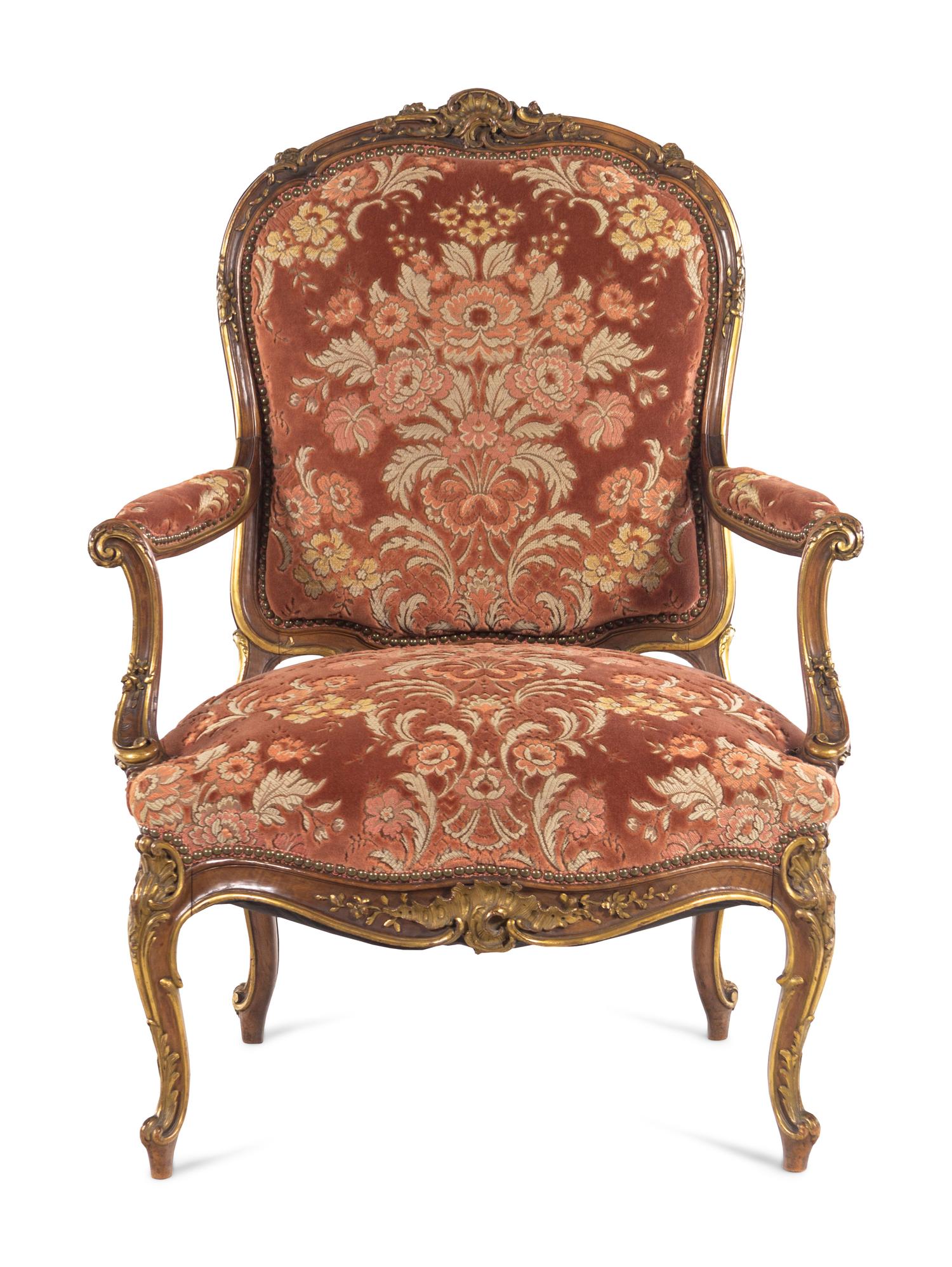 A Louis XV Style Carved and Parcel Gilt Walnut Fauteuil