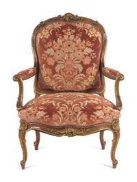 A Louis XV Style Carved and Parcel Gilt Walnut Fauteuil