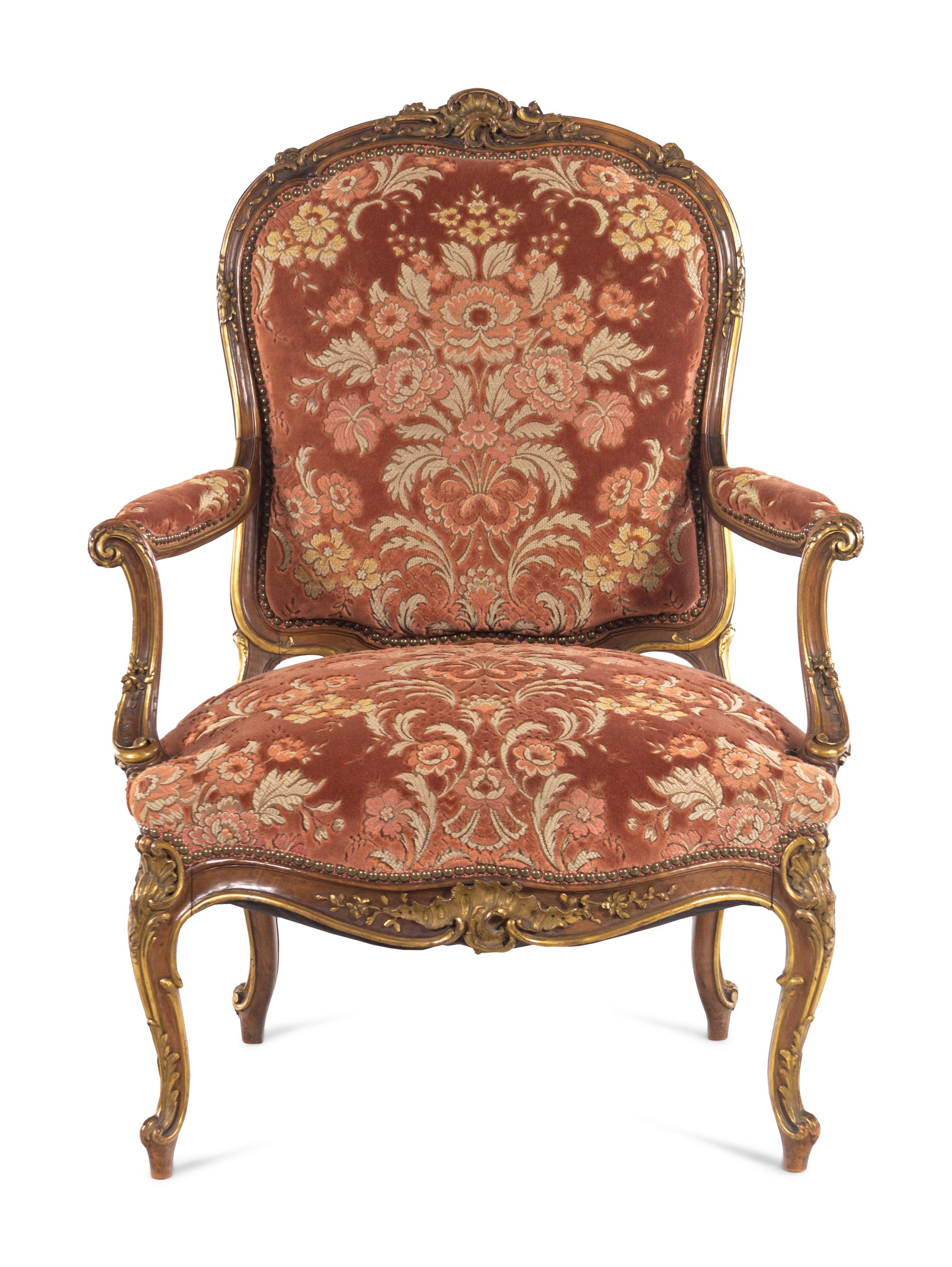 A Louis XV Style Carved and Parcel Gilt Walnut Fauteuil