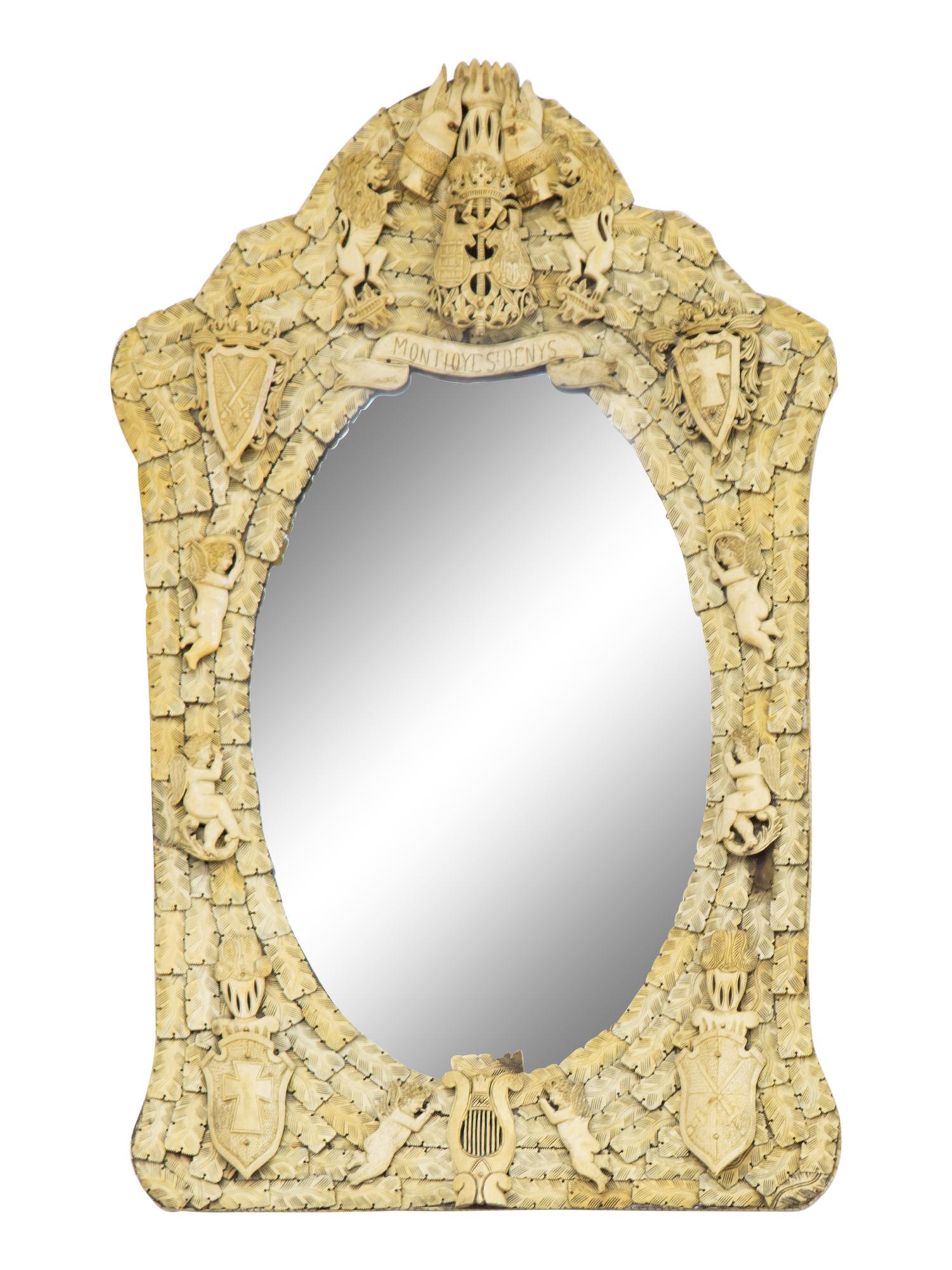 A Continental Carved Bone Mirror with Coat of Arms, Putti and Shields