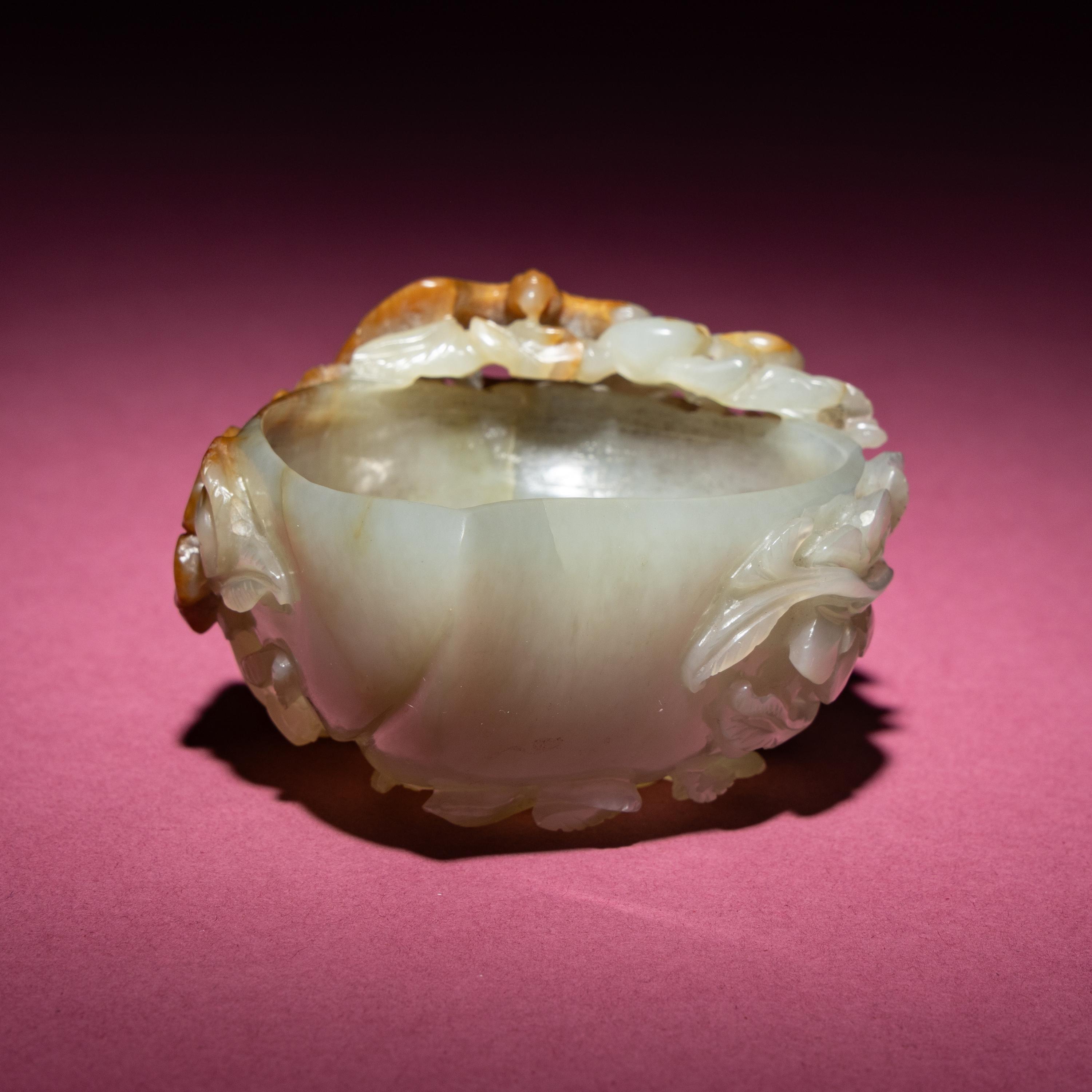 A Chinese Russet and Celadon Jade ‘Magpie and Plum Blossoms’ Peach-Form Coupe, 19th Century — 清晚期 青白玉帶皮喜上眉梢桃形杯