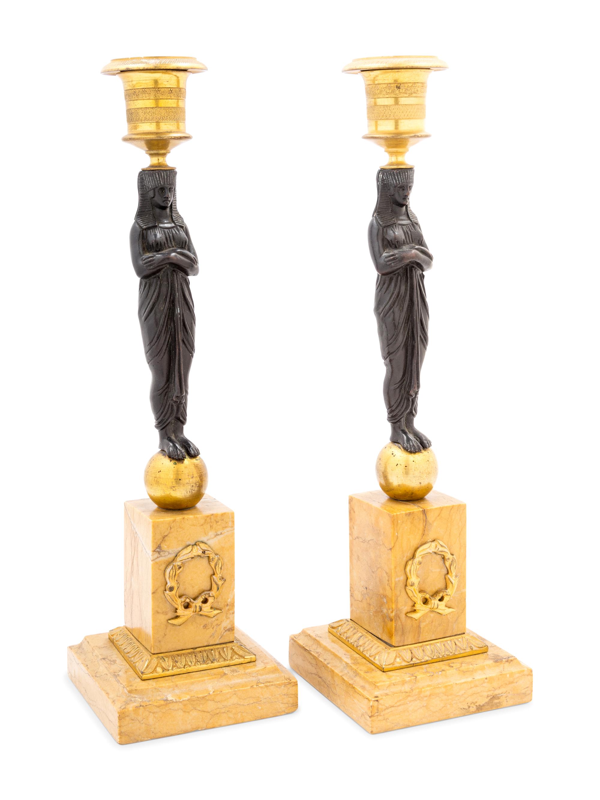 A Pair of French Egyptian Revival Bronze and Marble Candlesticks
