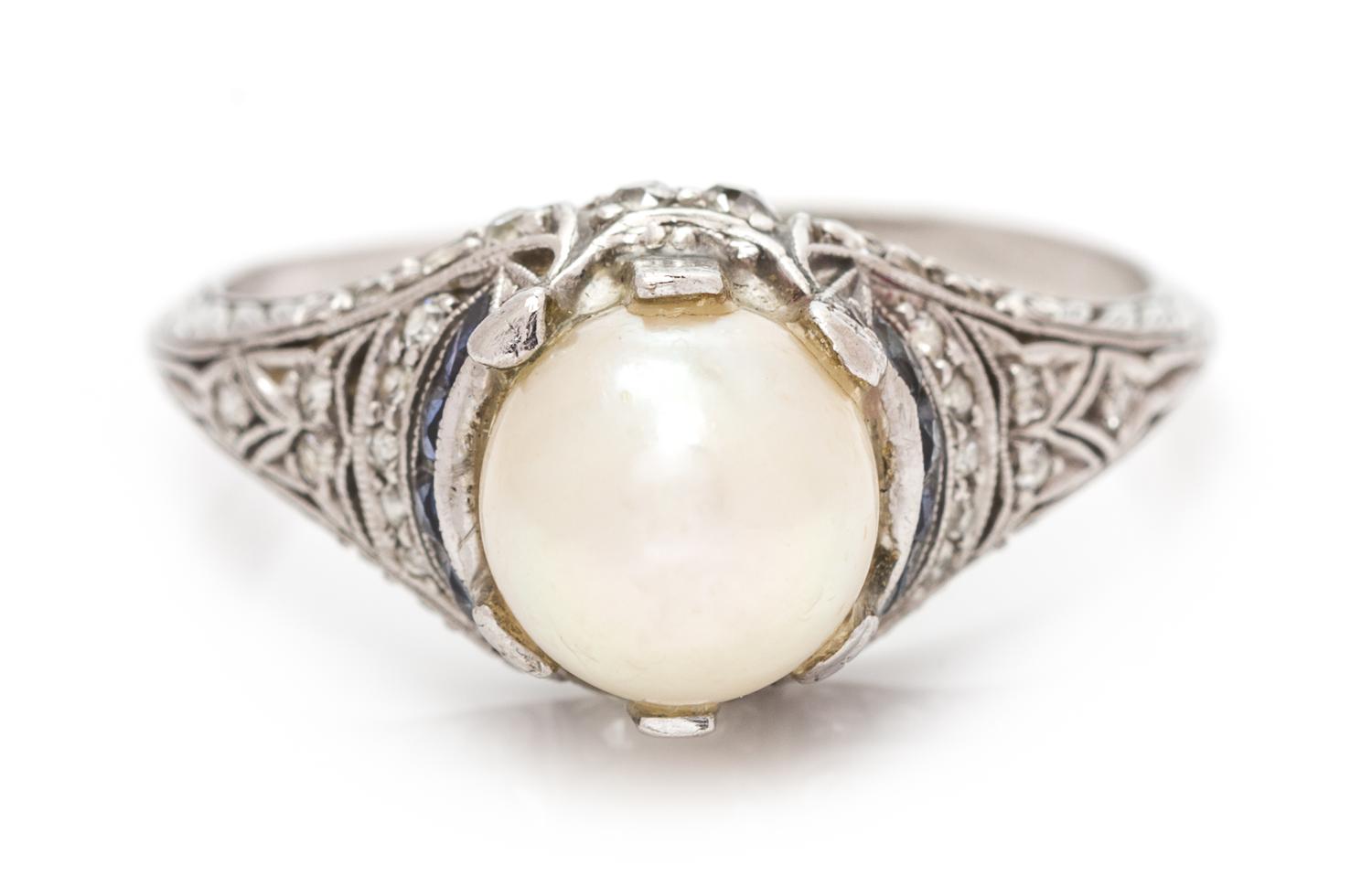 An Art Deco Platinum, Pearl, Diamond and Sapphire Ring, 2.30 dwts.