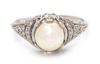 An Art Deco Platinum, Pearl, Diamond and Sapphire Ring, 2.30 dwts.