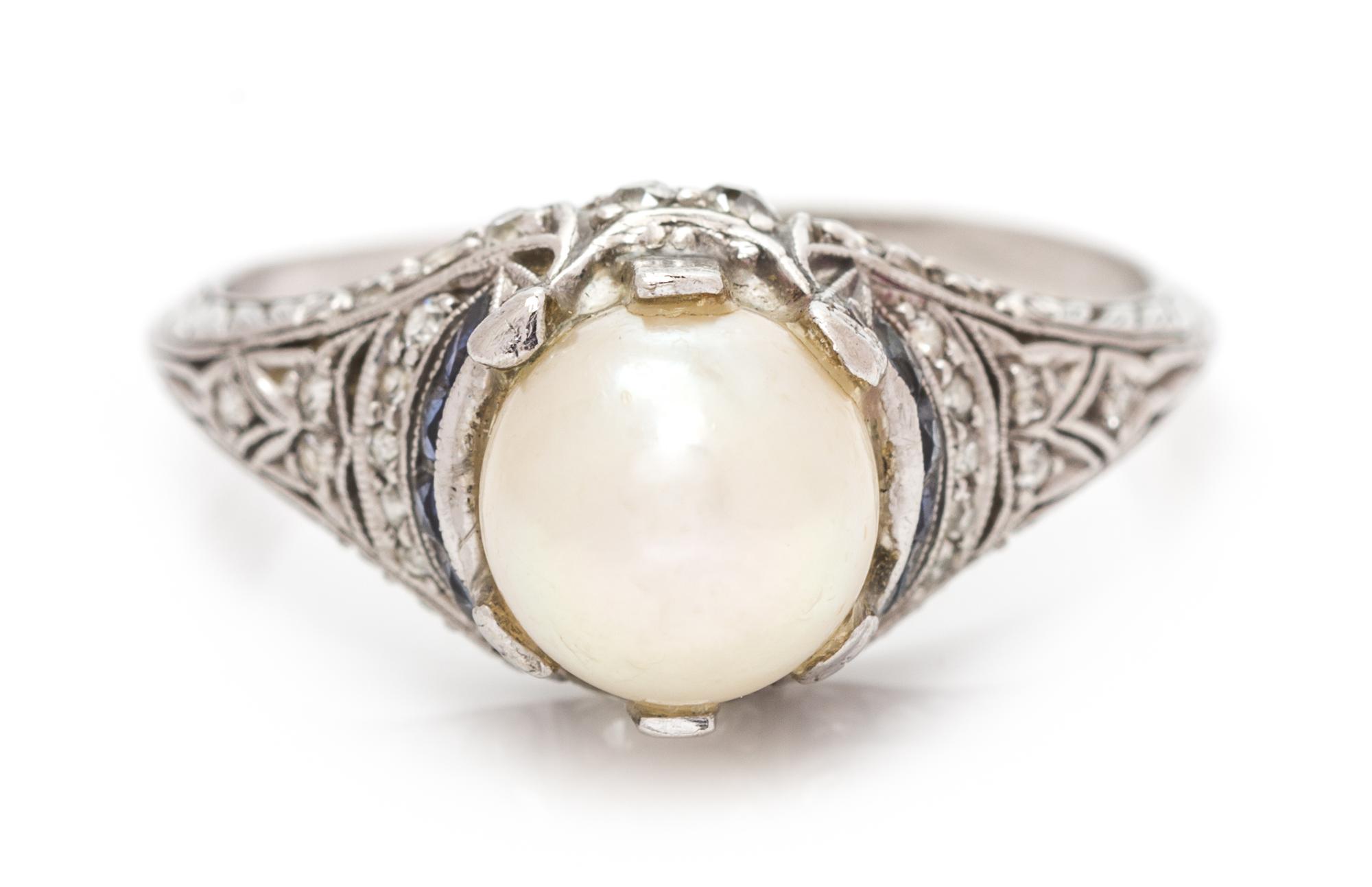 An Art Deco Platinum, Pearl, Diamond and Sapphire Ring, 2.30 dwts.