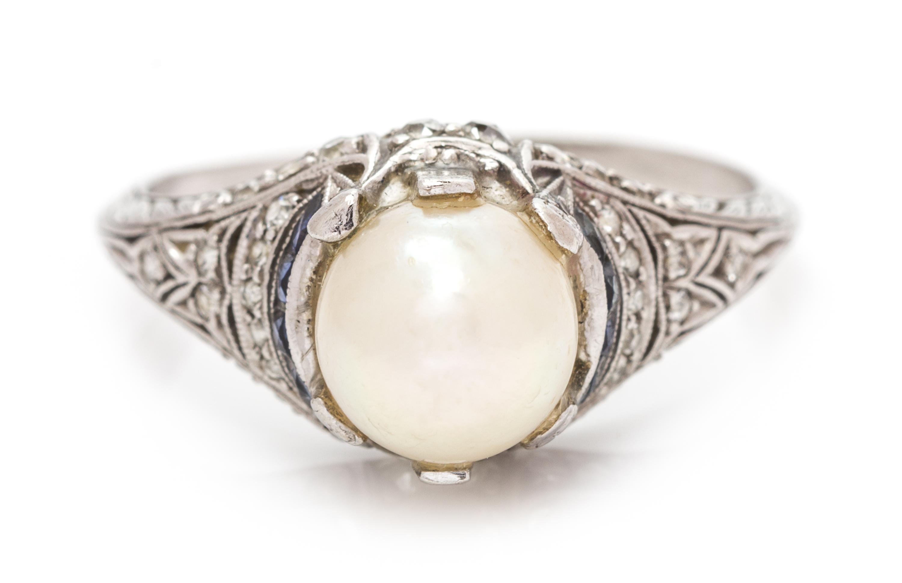 An Art Deco Platinum, Pearl, Diamond and Sapphire Ring, 2.30 dwts.