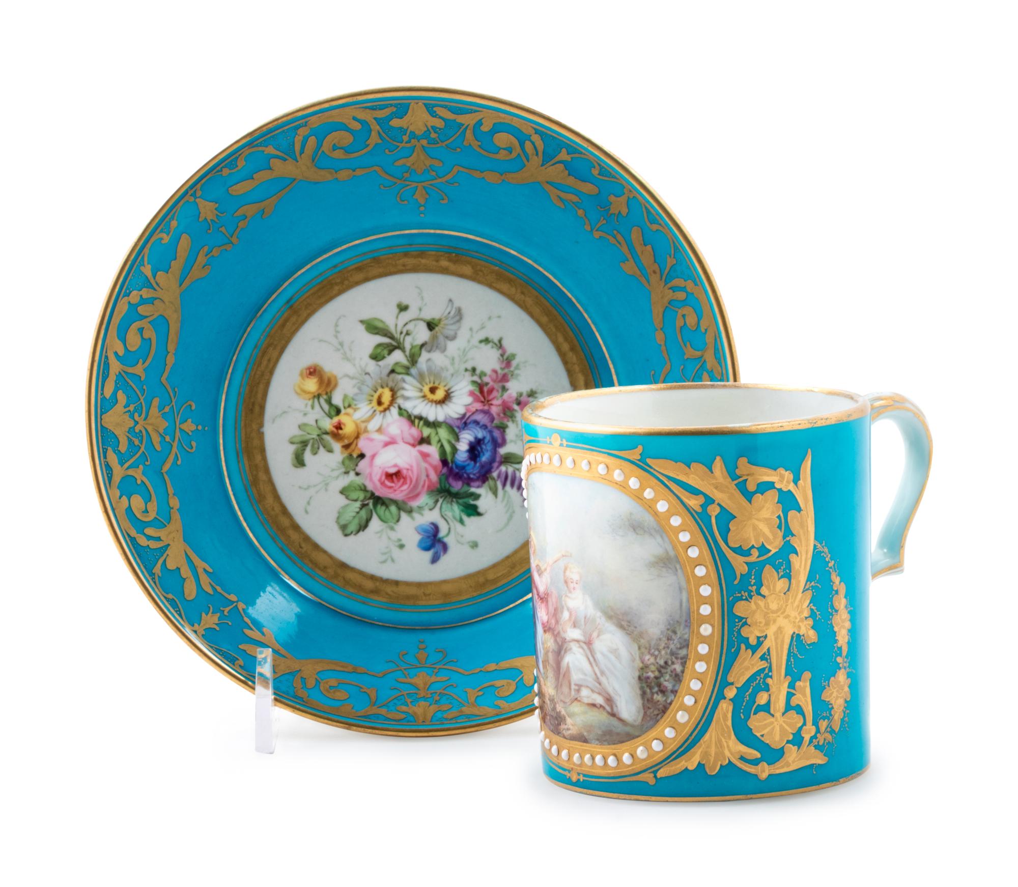 A Sèvres Style Painted, Parcel Gilt and "Jeweled" Turquoise-Ground Porcelain Cup and Saucer