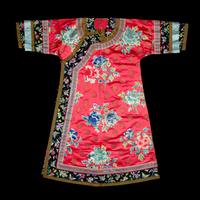 A Chinese Red Ground Embroidered Silk Manchu Lady's Informal Robe, Changyi, Late 19th Century 清晚期 桃紅緞綉牡丹團壽紋氅衣
