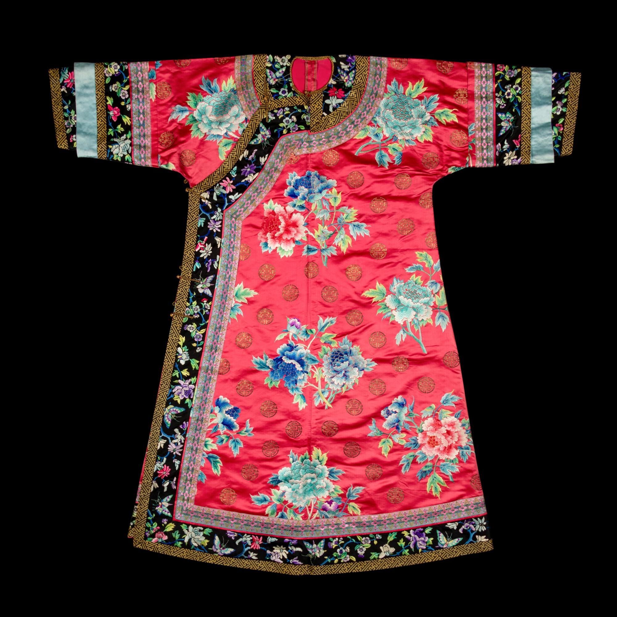 A Chinese Red Ground Embroidered Silk Manchu Lady's Informal Robe, Changyi, Late 19th Century 清晚期 桃紅緞綉牡丹團壽紋氅衣