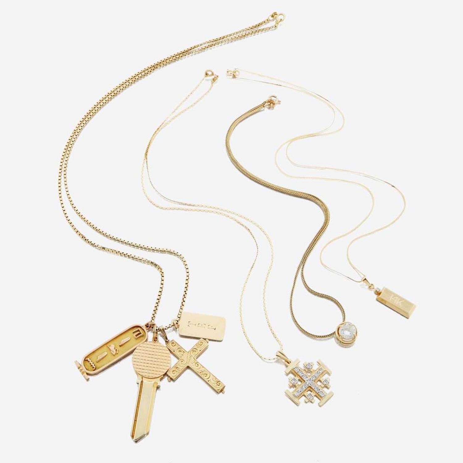 A collection of four gold necklaces