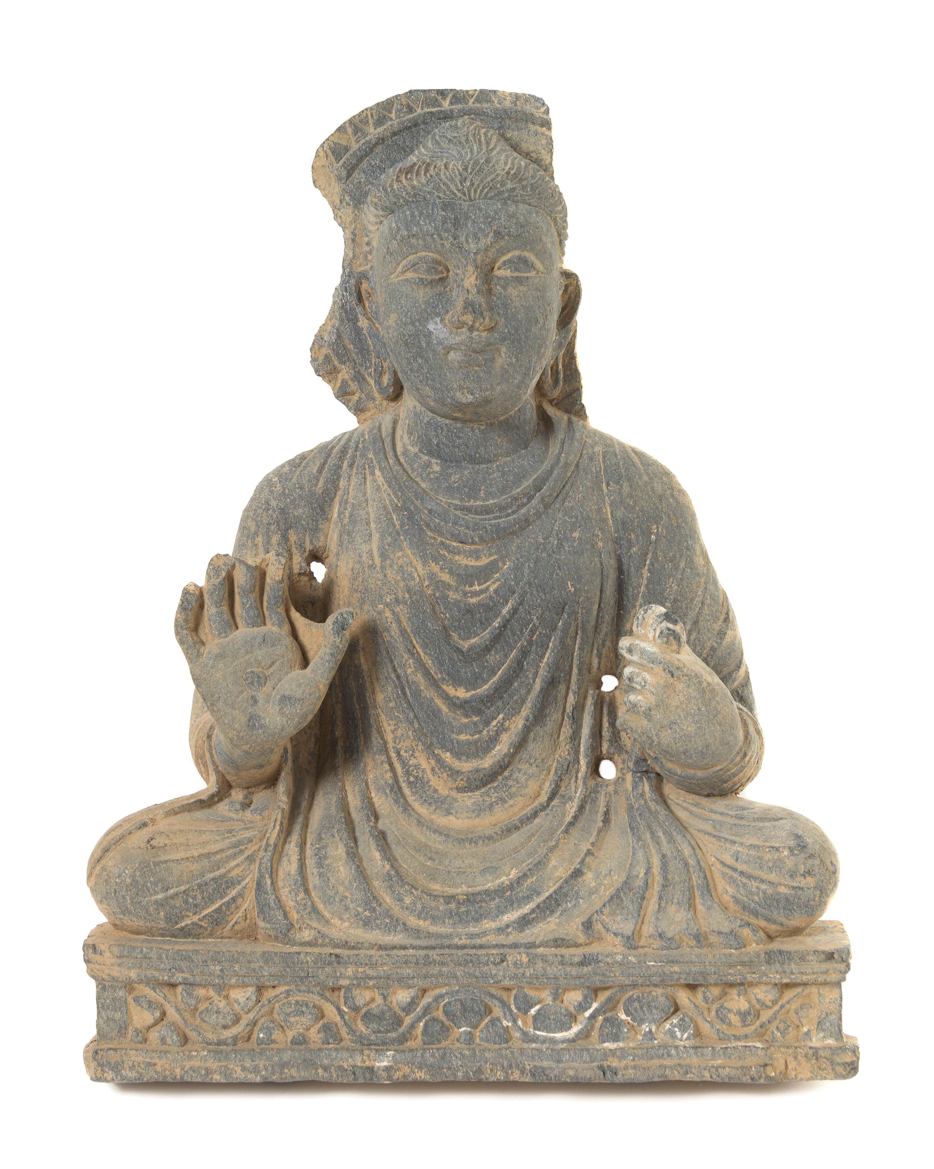 A Gandharan Schist Figure of a Seated Buddha Height 18 1/2 inches. — CIRCA 12TH-13TH CENTURY