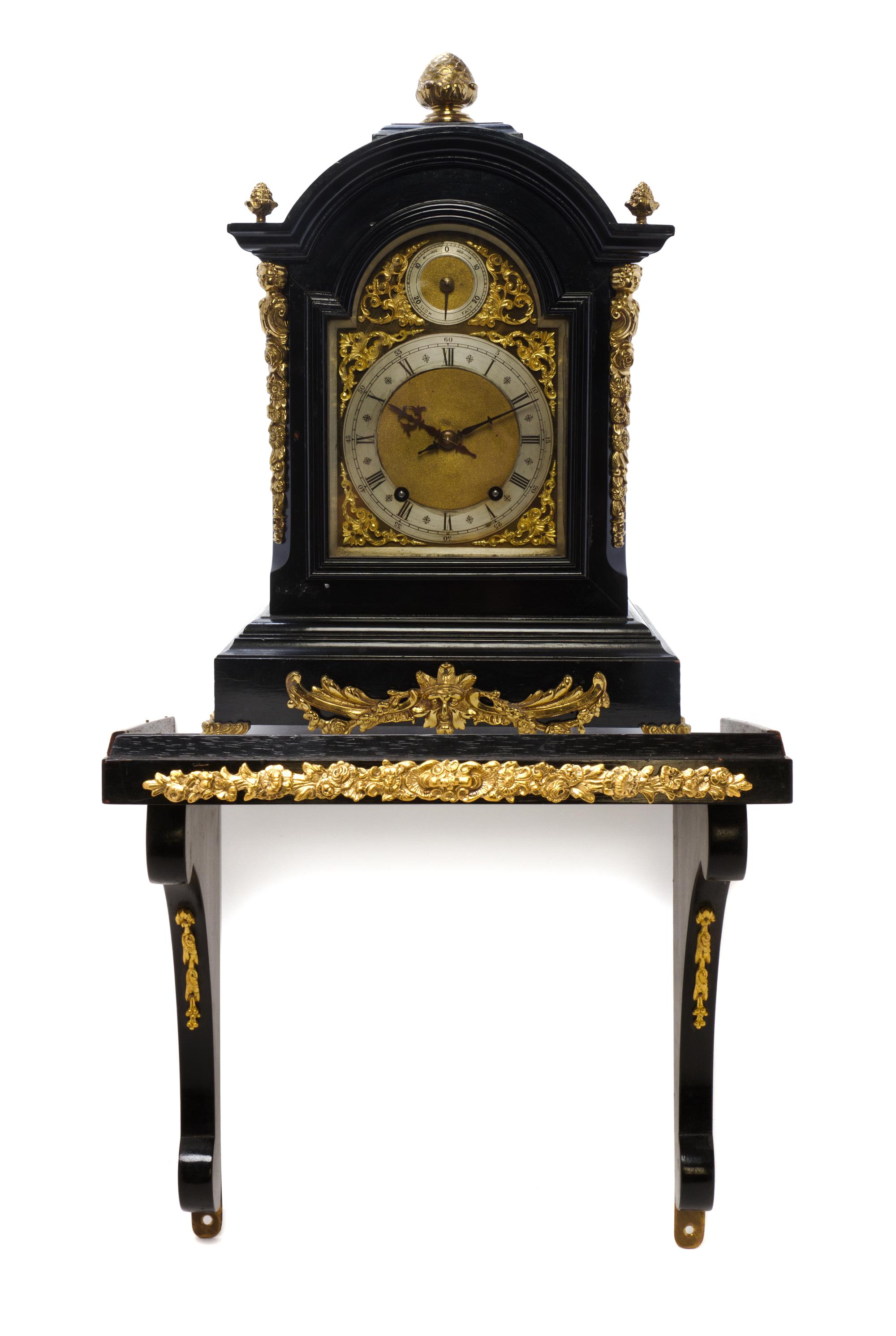 An English Gilt Metal Mounted Ebonized Bracket Clock, Height overall 32 inches.