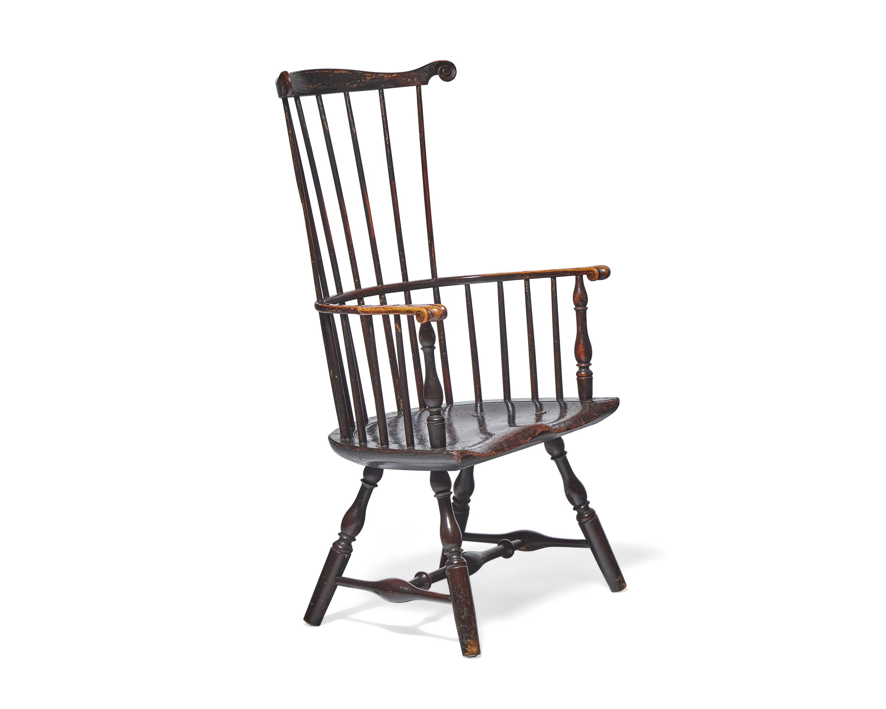 A Turned and Black-Painted Comb-Back Windsor Armchair