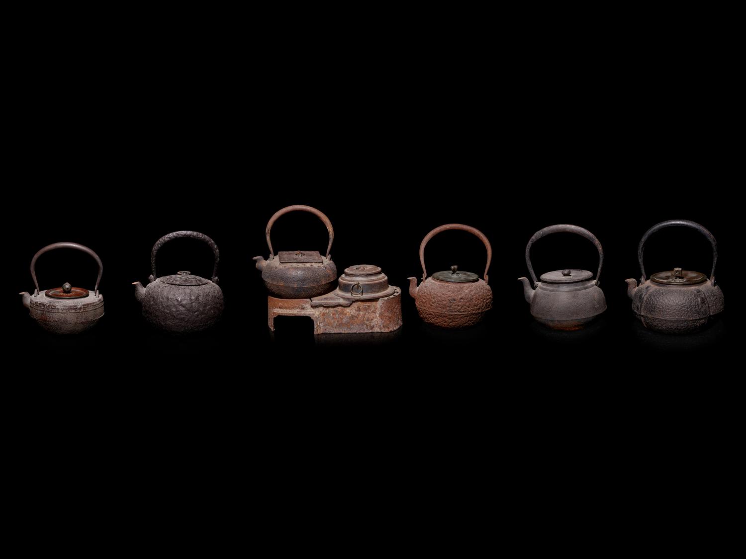 Seven Japanese Cast Iron Teapots, Tetsubin, and Burner