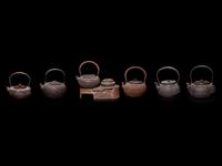 Seven Japanese Cast Iron Teapots, Tetsubin, and Burner