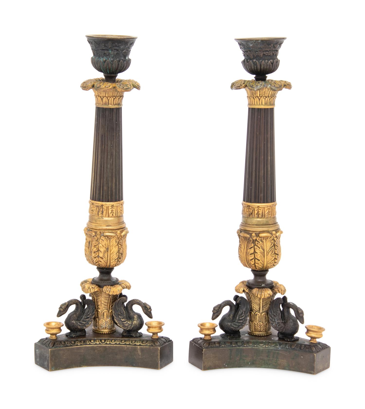 A Pair of French Parcel Gilt and Patinated Bronze Candlesticks