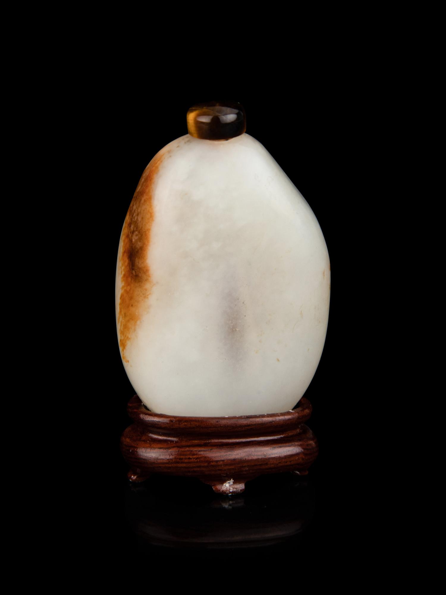 A Chinese White and Russet Jade Pebble-Form Snuff Bottle