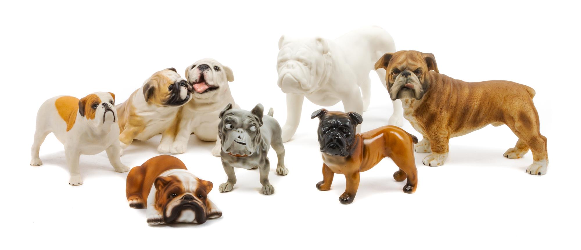 A Group of Seven Porcelain and Bisque Bulldogs Width of widest 8 1/4 inches.