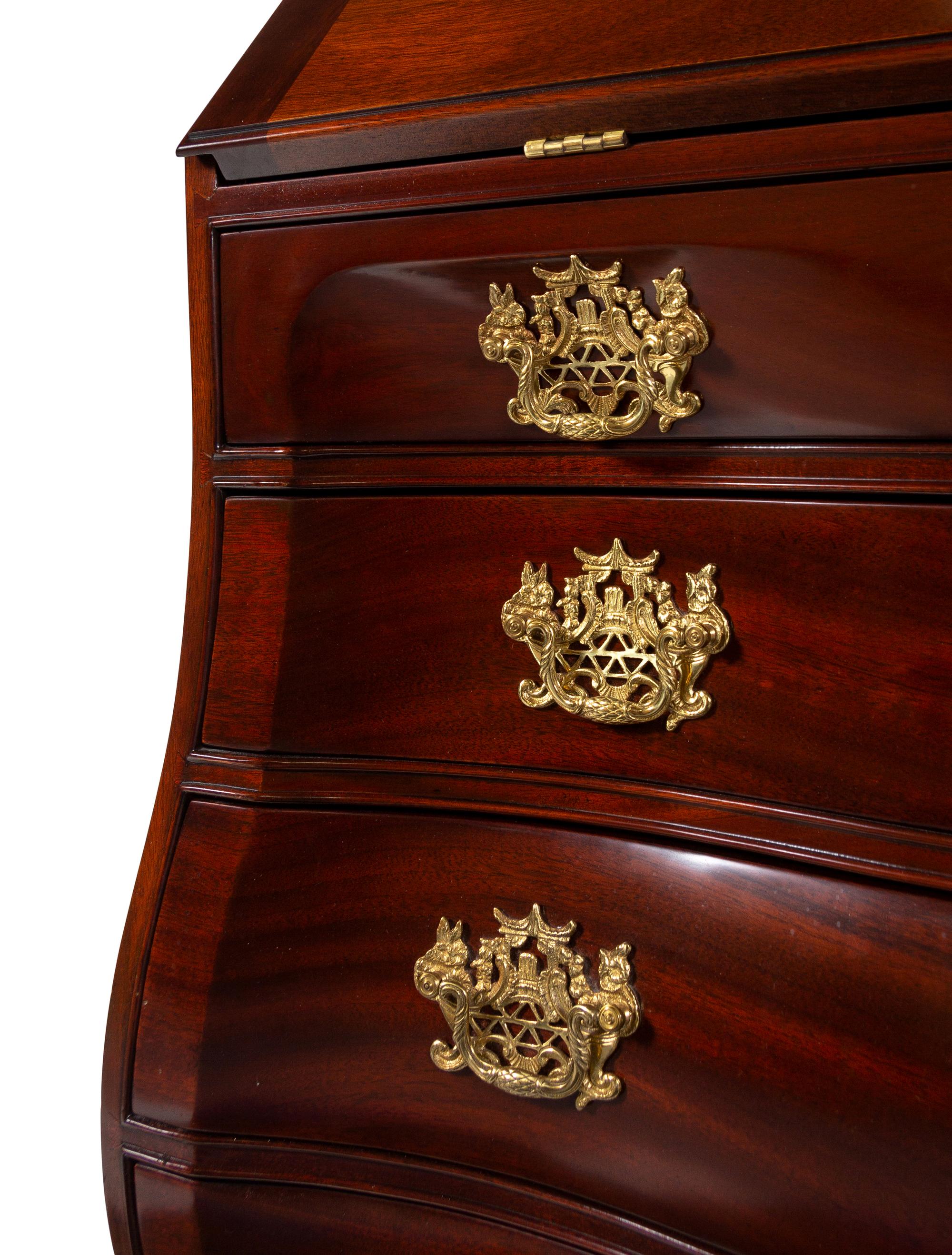 A Chippendale Style Carved Mahogany Bombe-Form Slant-Front Desk
