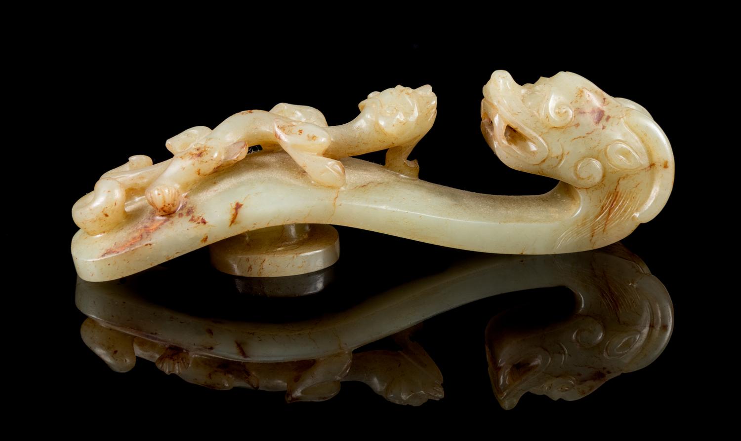A Carved Celadon and Russet Jade Belt Hook Length 4 1/4 inches. — 18TH/19TH CENTURY