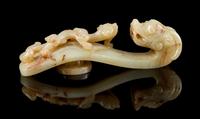A Carved Celadon and Russet Jade Belt Hook Length 4 1/4 inches. — 18TH/19TH CENTURY
