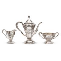 An Art Nouveau Three-Piece Sterling Silver Floral Cast and Repousse Coffee Service