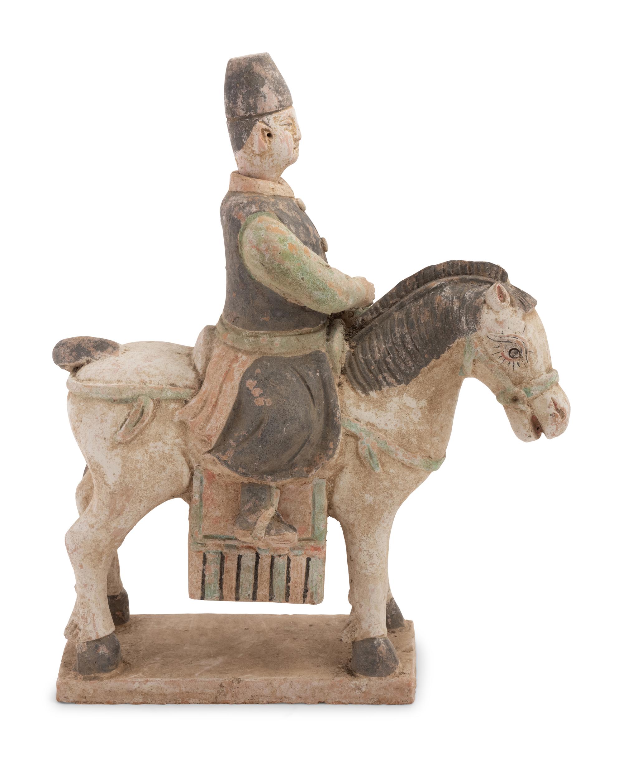 A Chinese Painted Terra Cotta Burial Figure of a Mounted Attendant
