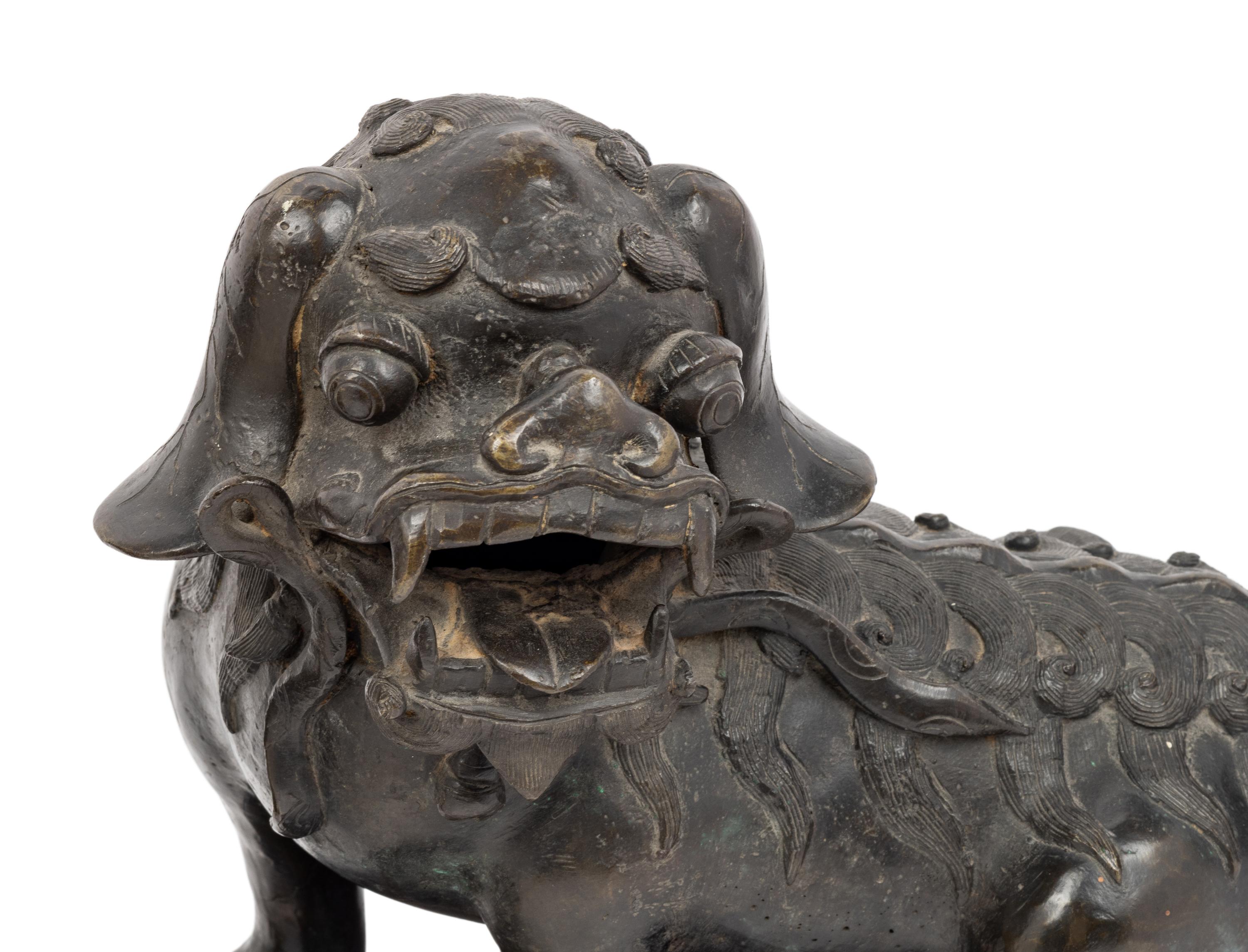 A Pair of Chinese Bronze Buddhistic Lions with Wood Stands
