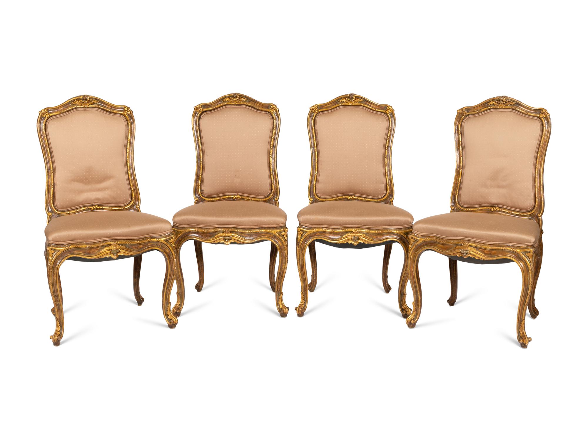 A Set of Four Louis XV Style Painted and Parcel Gilt Dining Chairs