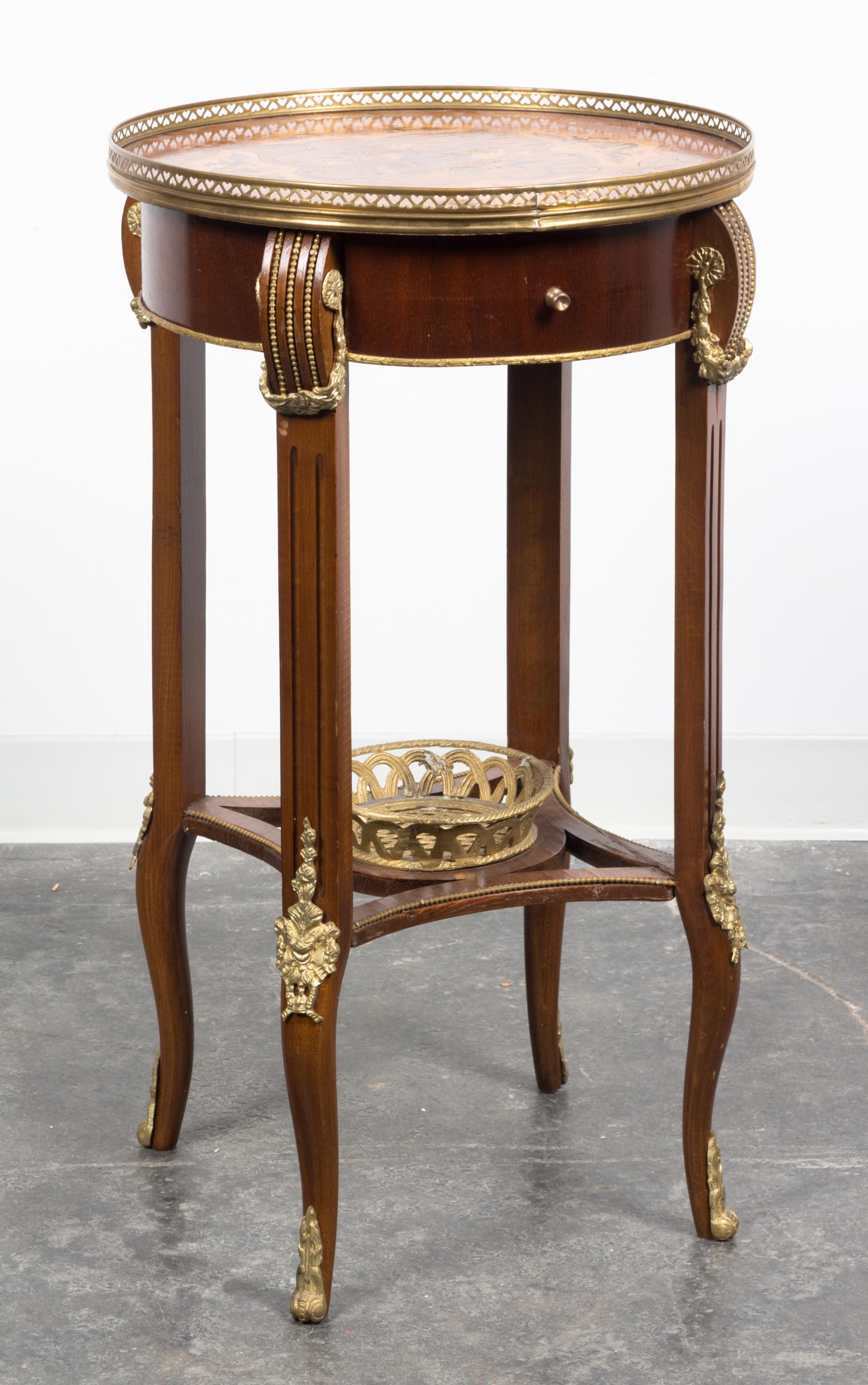 A Louis XVI Style Gilt Metal Mounted Marquetry Decorated Table Height 31 1/8 x diameter 17 1/2 inches. — 20TH CENTURY