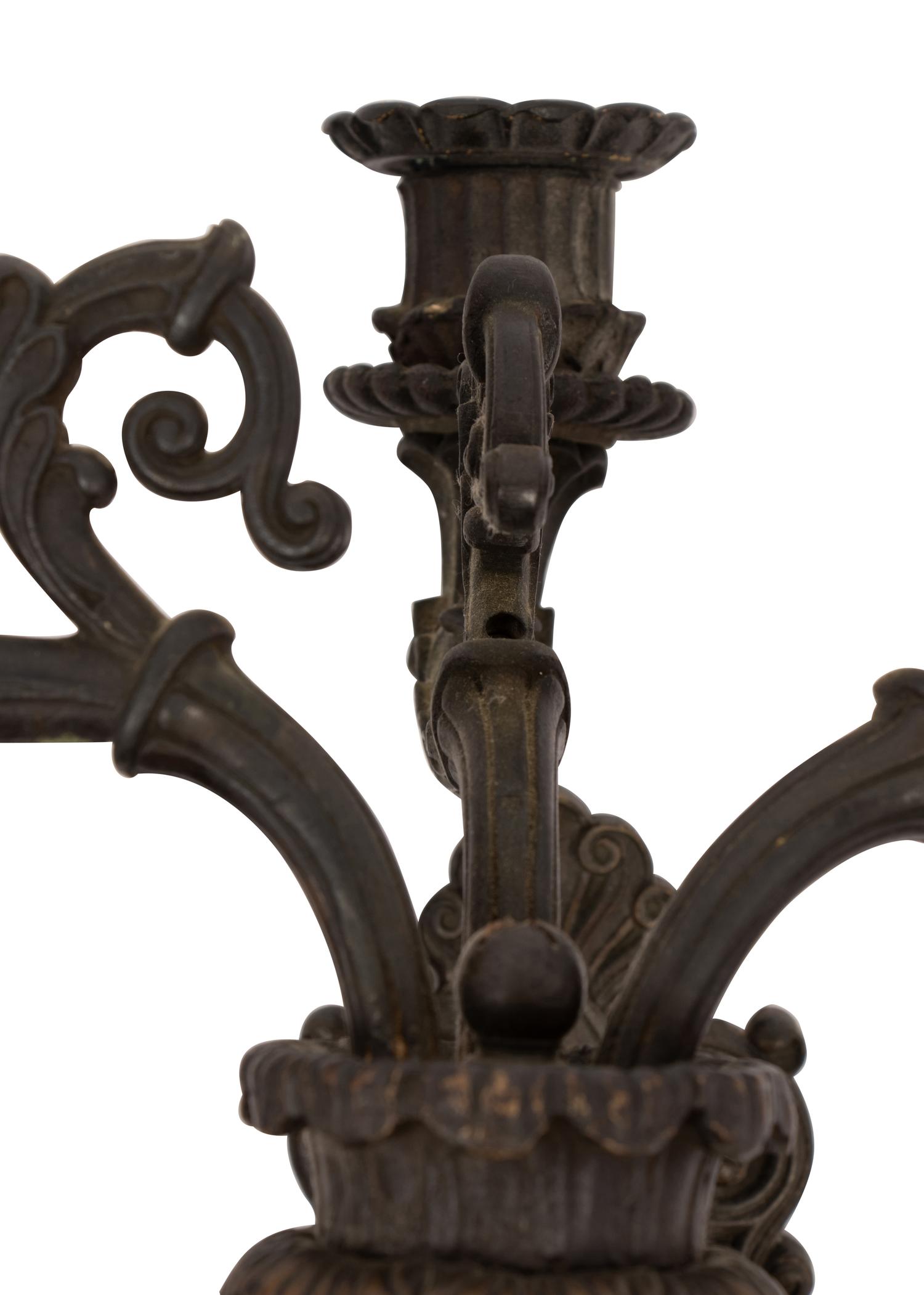 A Pair of Neoclassical Patinated Metal Three-Light Wall Sconces