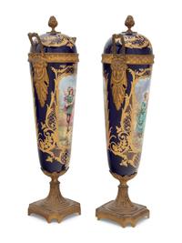 A Pair of Sèvres Style Gilt Bronze Mounted Porcelain Urns