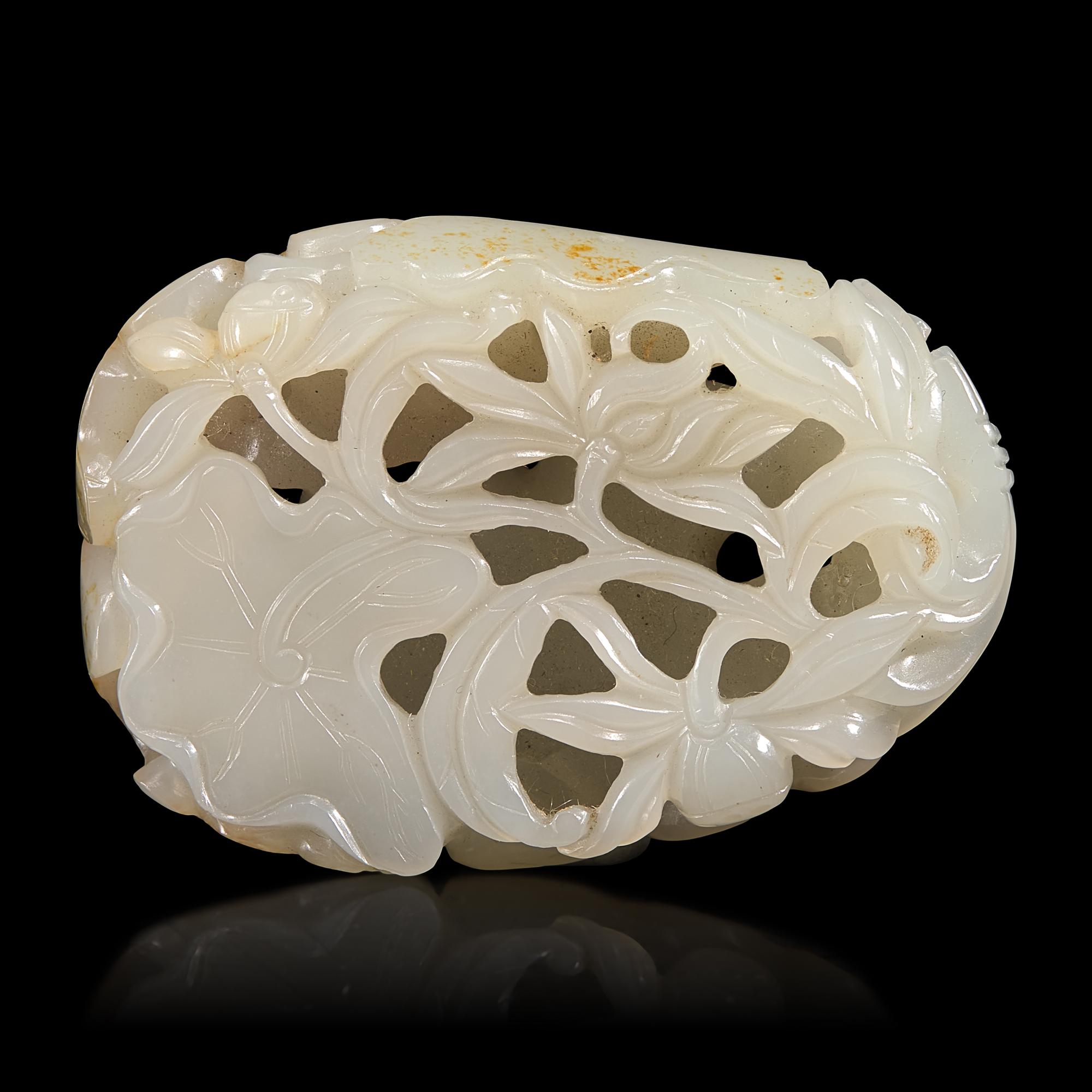 A Chinese White and Russet Jade 'Lotus' Pendant, 18th/19th Century — 清中期 白玉帶皮鏤雕蓮塘荷葉佩
