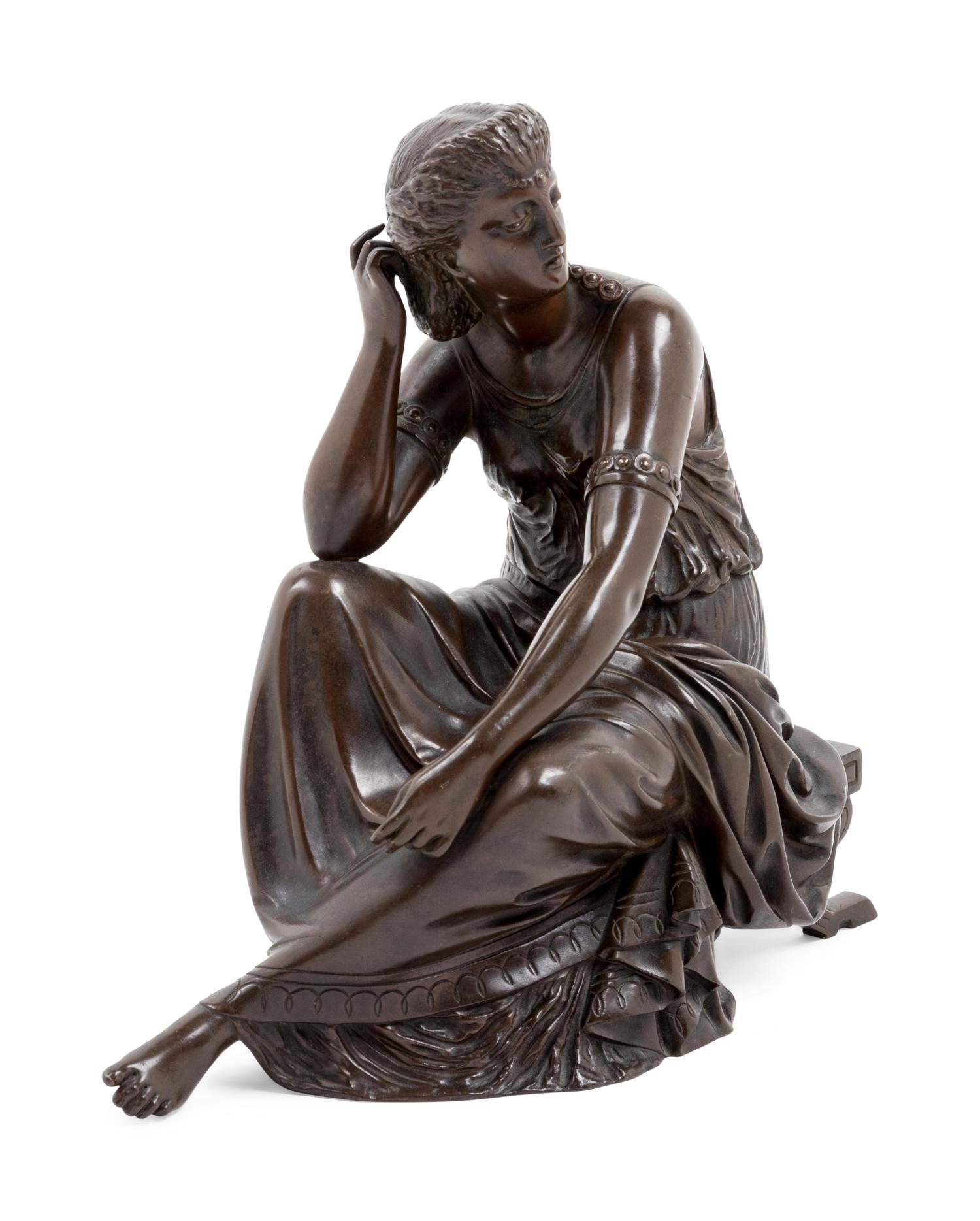 A Continental Patinated Bronze Seated Maiden