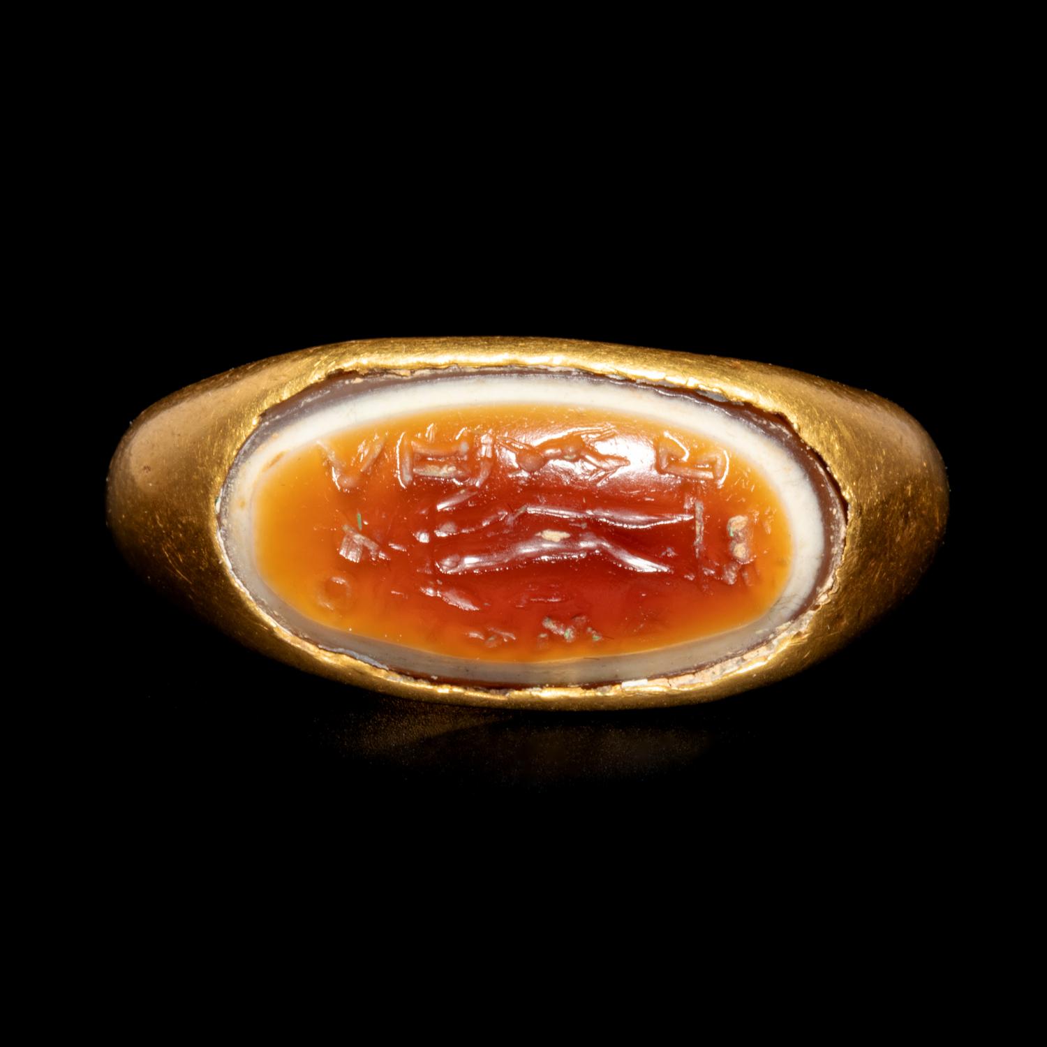 A Hellenistic Gold Finger Ring with Banded Agate Intaglio of Nude Deity