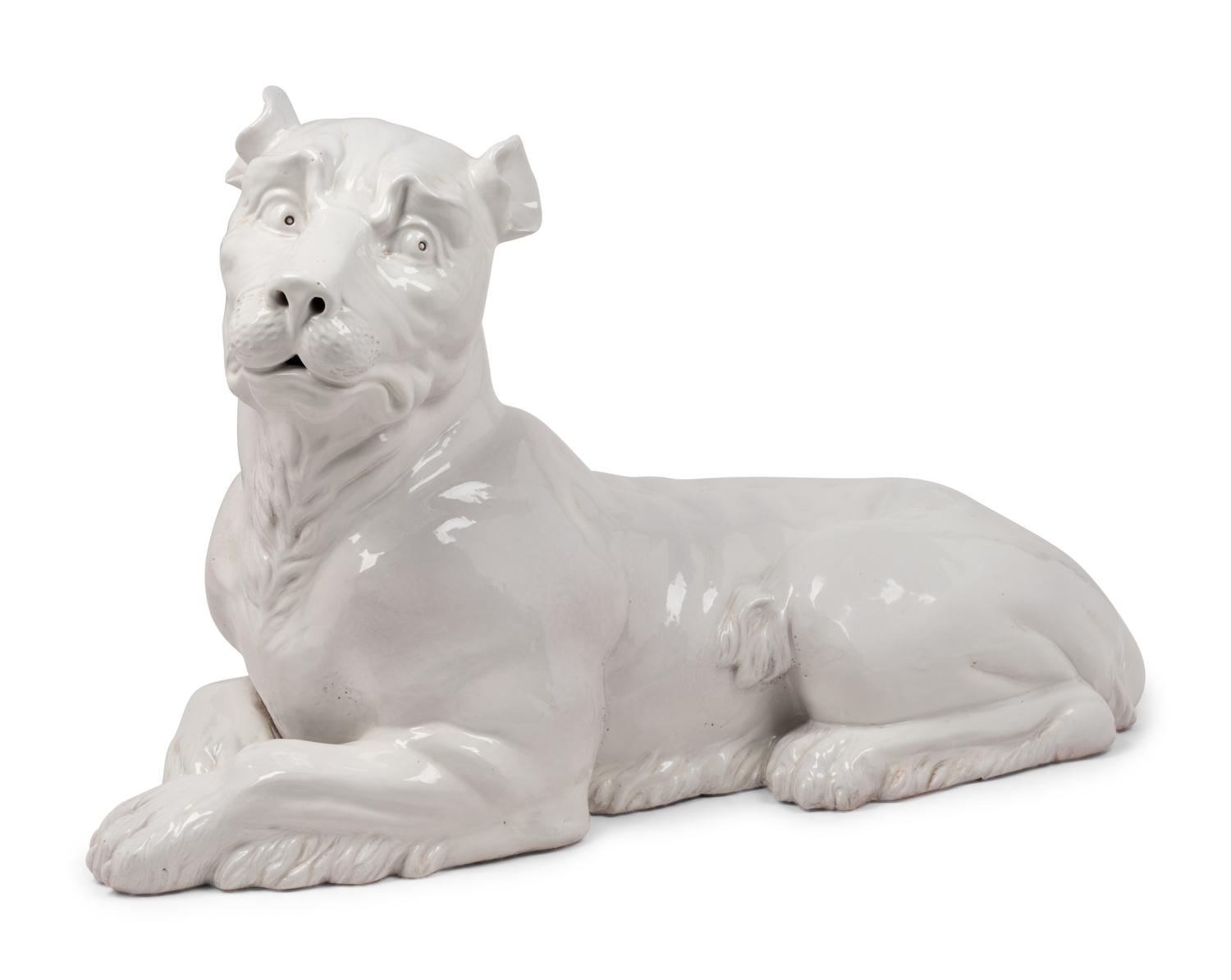 An Italian Painted Terra Cotta Figure of a Recumbent Dog