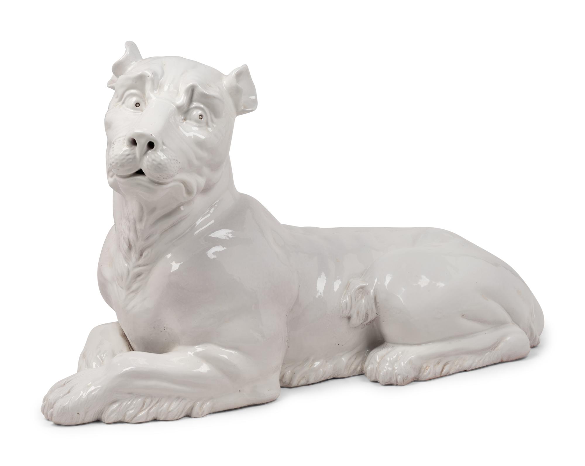 An Italian Painted Terra Cotta Figure of a Recumbent Dog