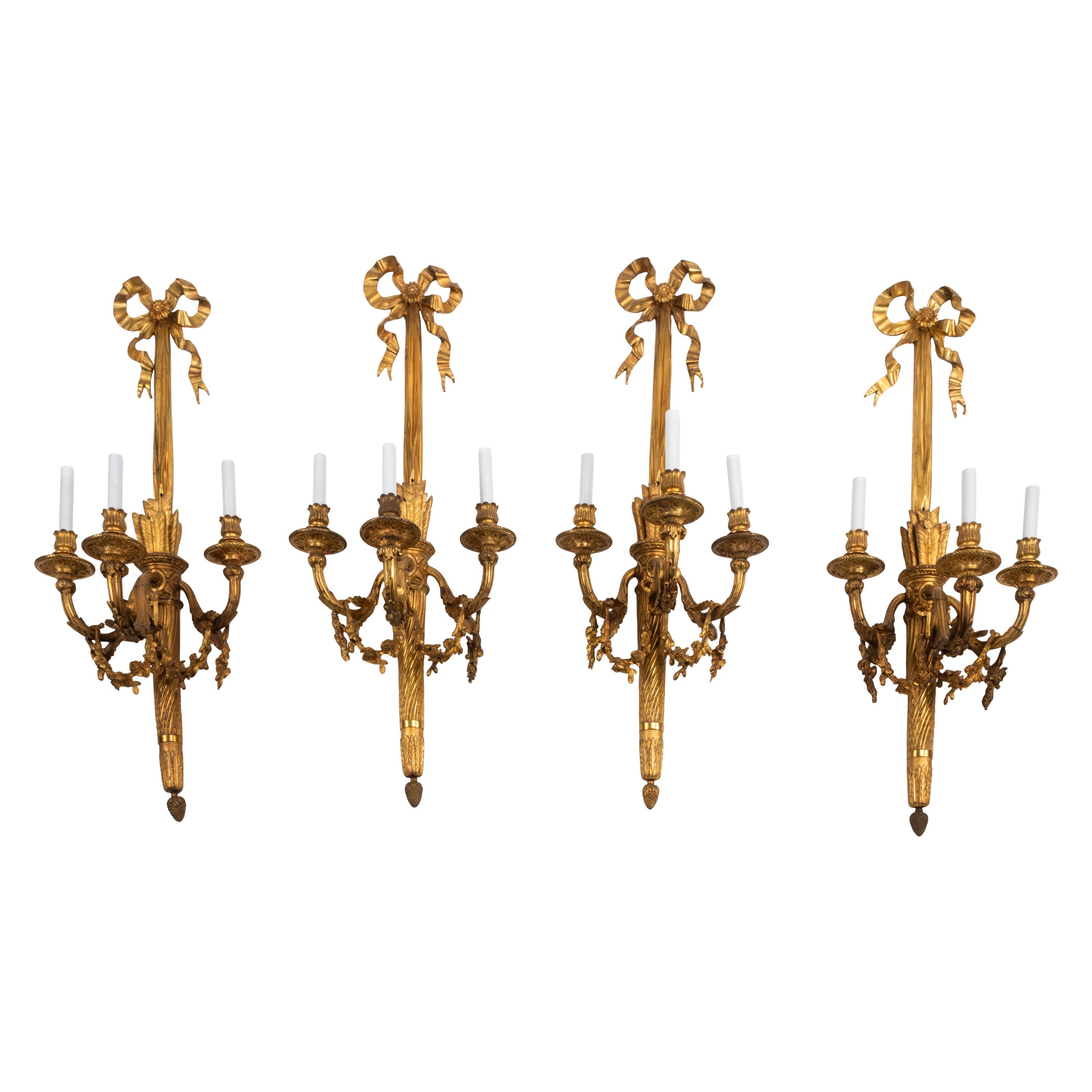 A Set of Four Large French Gilt Bronze Three-Light Sconces