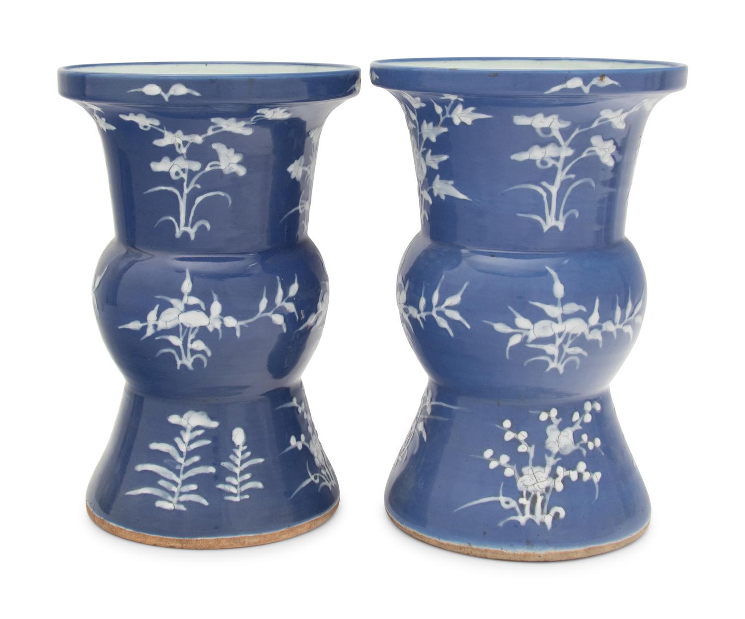 A Pair of Chinese Blue Ground White Slip Decorated Porcelain Spittoons