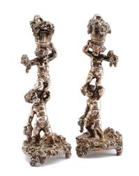 A Pair of Silver Figural Candlesticks, Circa 2000, each in the form of two Bacchanalian putti supporting a bushel of grape bunches, wei