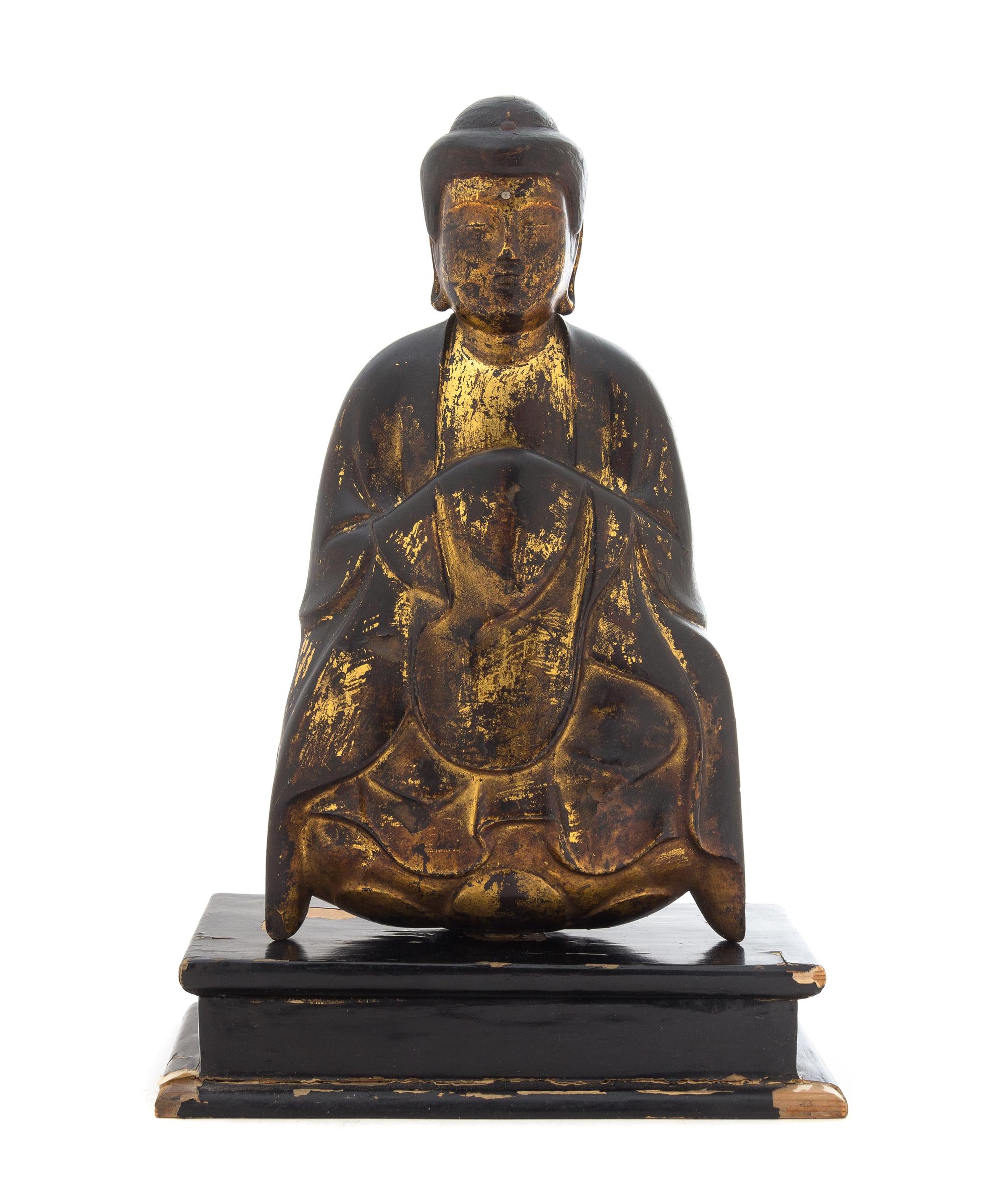 A Gilt and Black Lacquered Wood Figure of a Seated Shakyamuni Buddha Height of figure 12 1/4 inches.