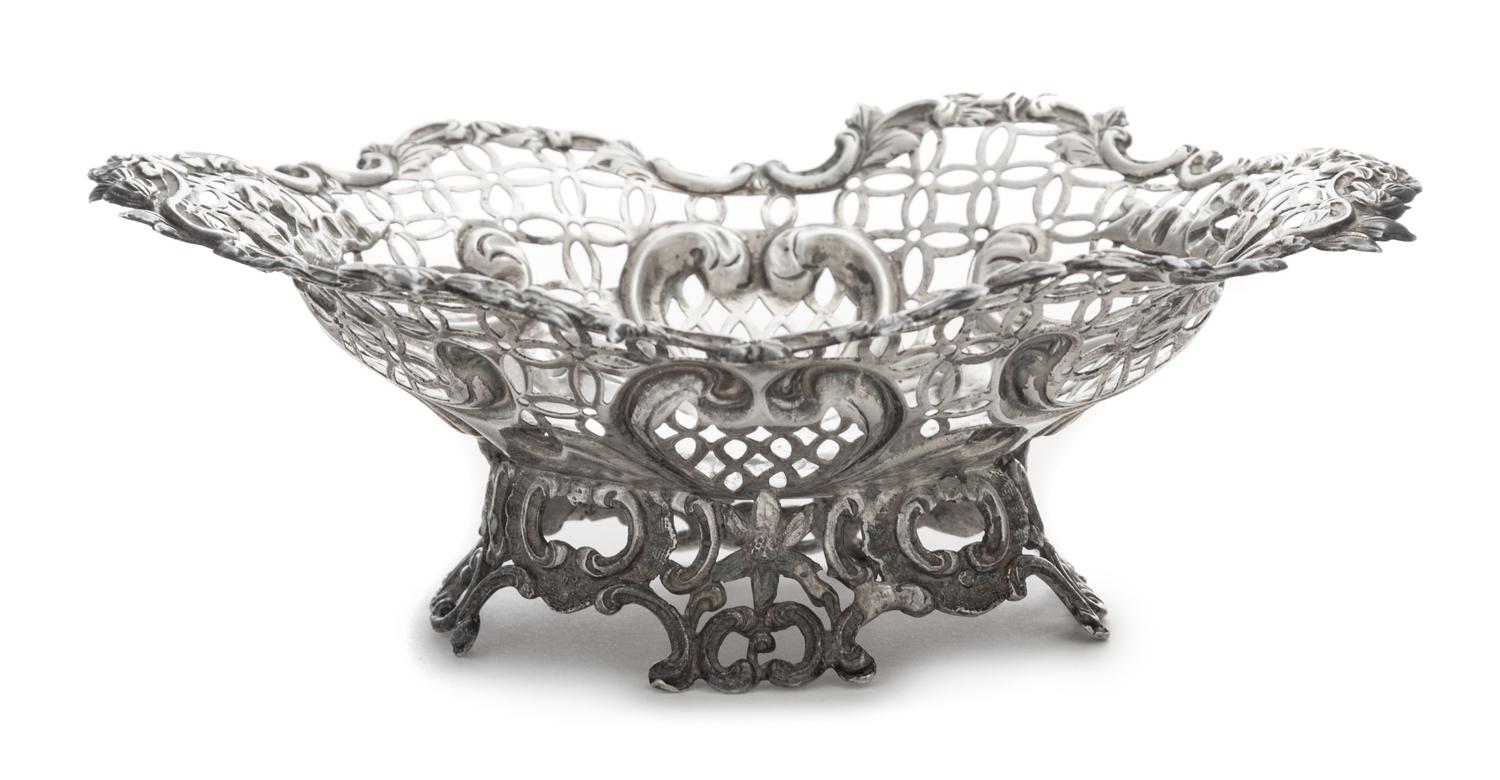 A Victorian Silver Basket, Likely William Comyns, London, 1890, having a pierced body with a C-scroll and floral decorated rim and base